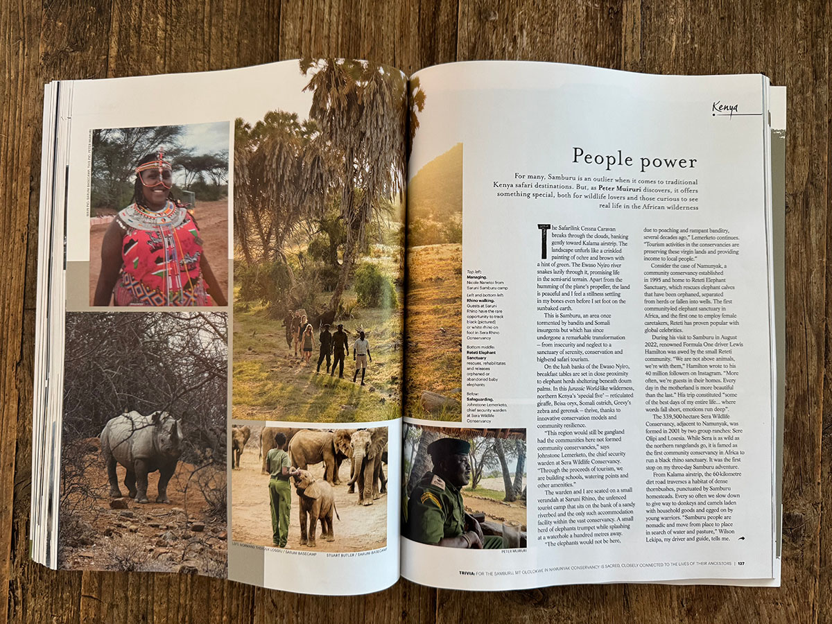 Travel Africa supporting field image showing an open magazine spread on a wooden surface.